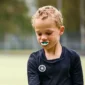 Child wearing a custom sports mouthguard to prevent sports-related dental injuries during summer activities
